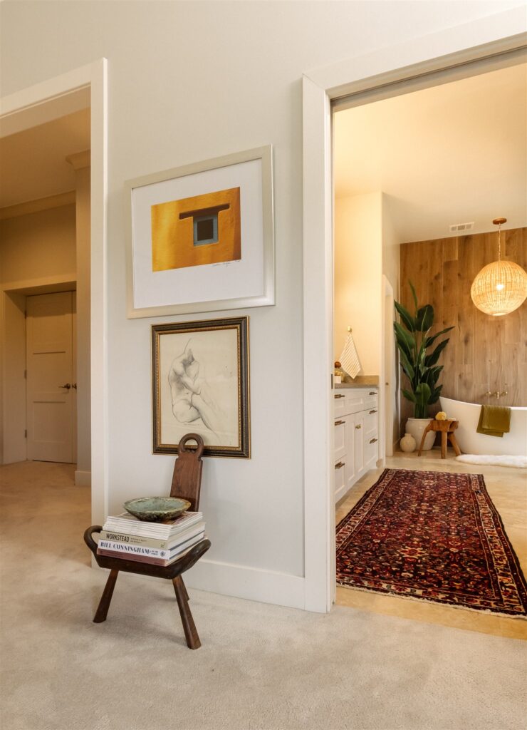 Sensory-friendly primary suite designed by Rachel Jackson Design with a freestanding tub and wood accent wall, featured in Good Housekeeping May/Jun '26